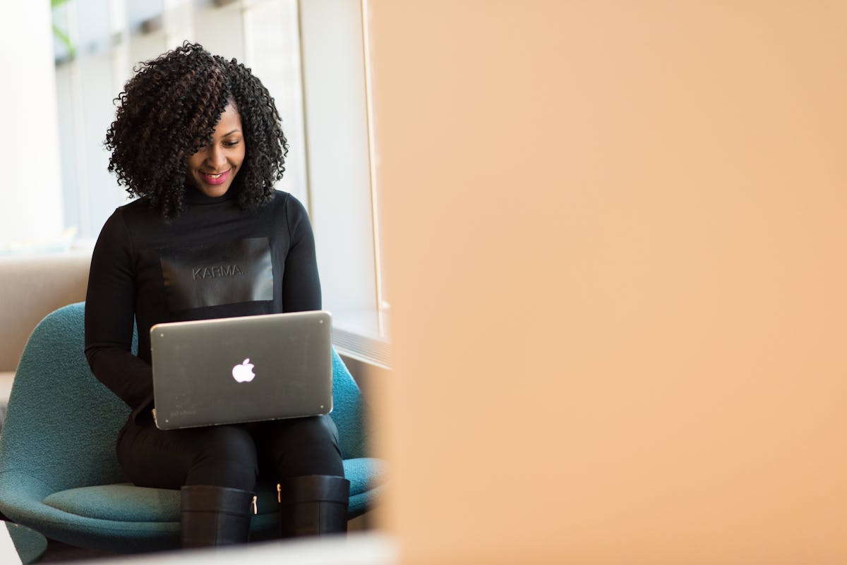 Woman working on laptop in modern workspace