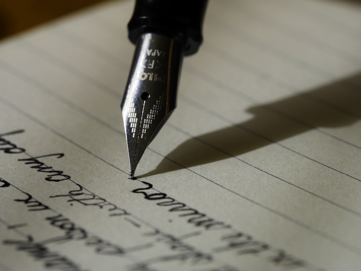 Person writing at a clean desk